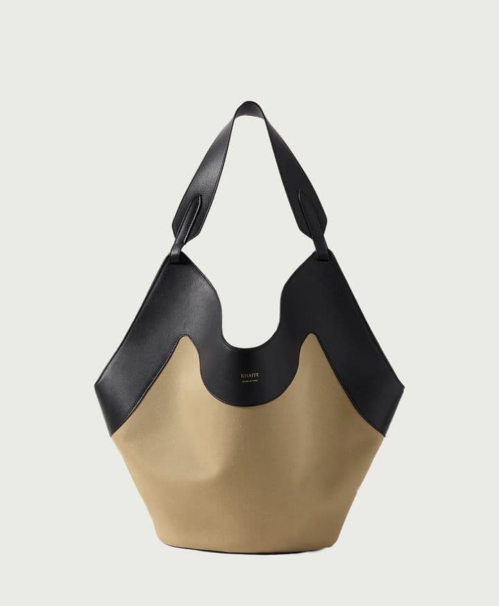 A scarf-inspired tote designed to be especially lightweight, with rounded base for stability. Includes removable leather pouch and dust bag.