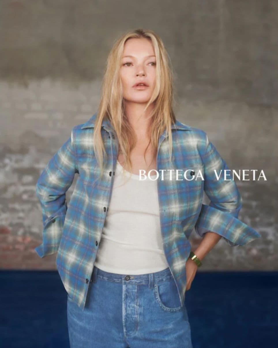 Kate Moss wearing Jeans and a checkered shirt with a white tank top underneath